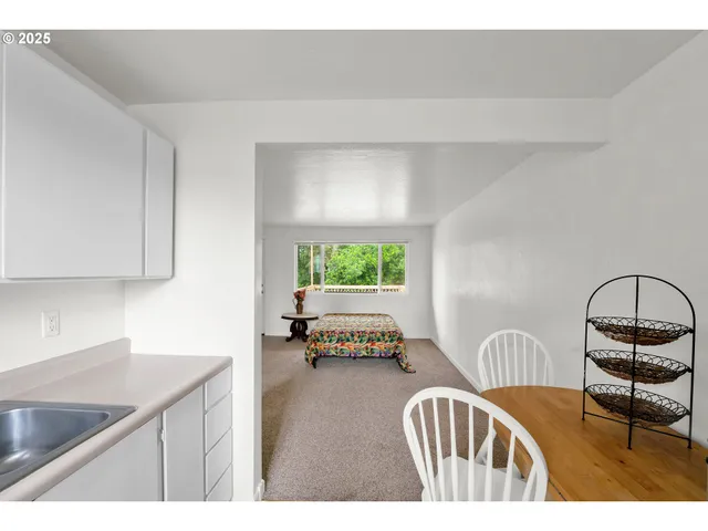 a open kitchen with furniture and a window