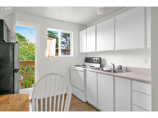 a kitchen with a sink cabinets and window