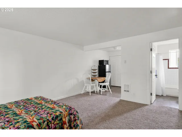 a bedroom with a bed and a chair