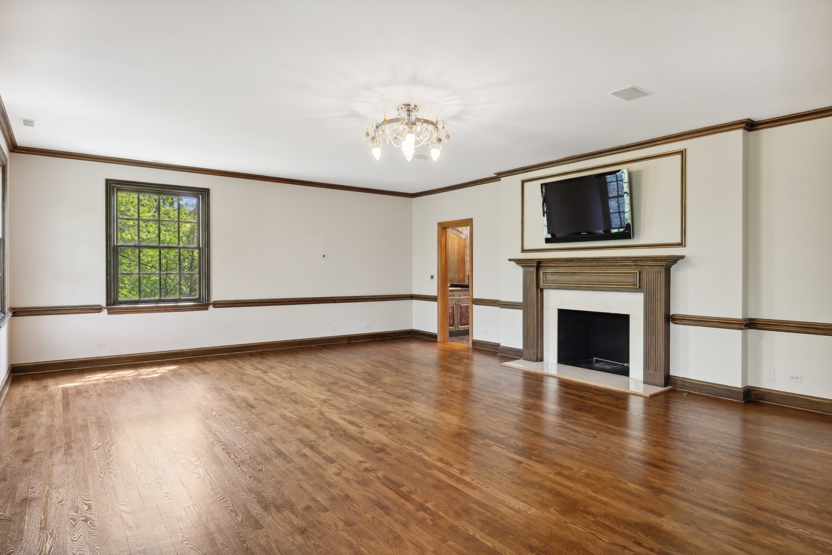 905 Voltz Road Northbrook, IL 60062 - Photo 28 of 58 a view of empty room with wooden floor and fireplace