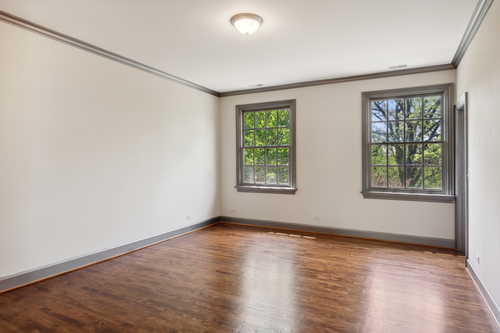 905 Voltz Road Northbrook, IL 60062 - Photo 34 of 58 an empty room with wooden floor and windows