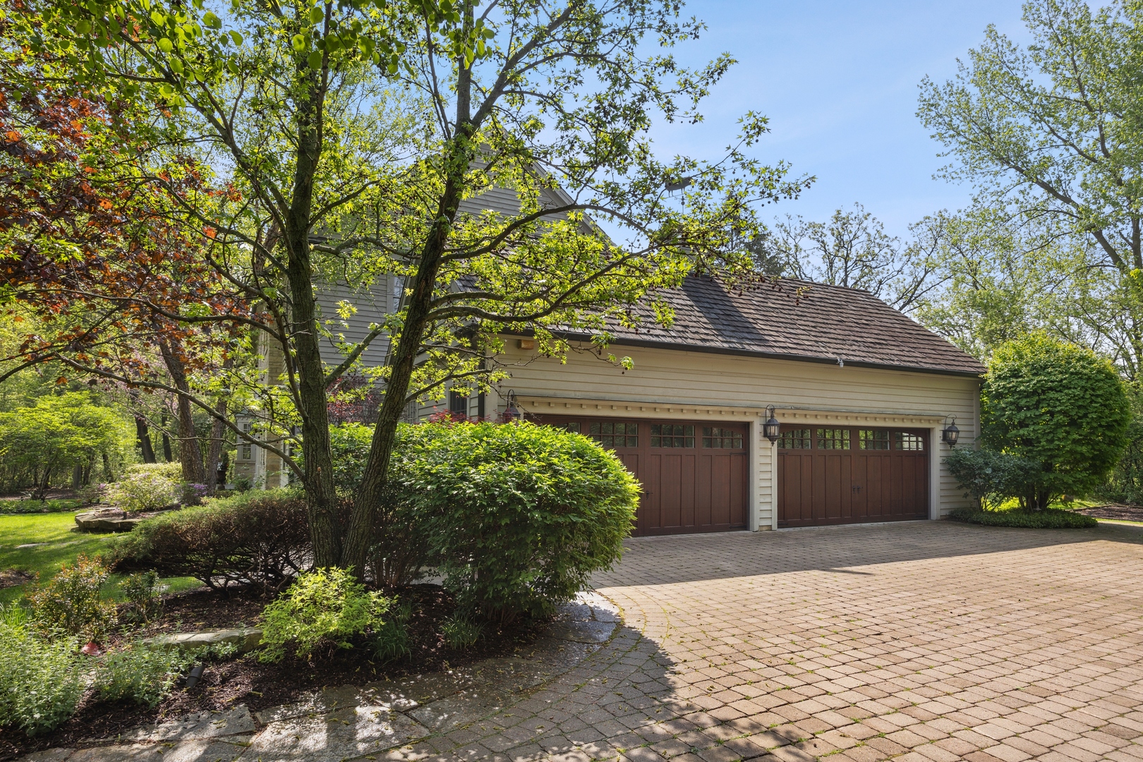 905 Voltz Road Northbrook, IL 60062 - Photo 7 of 58 a front view of a house with a yard and a garage