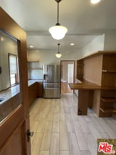 a view of hallway with stairs and wooden floor