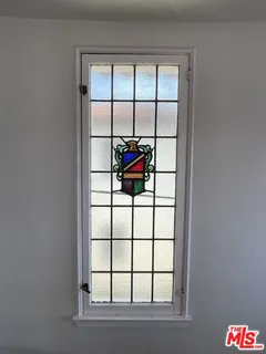 a view of empty room with wooden floor and fireplace