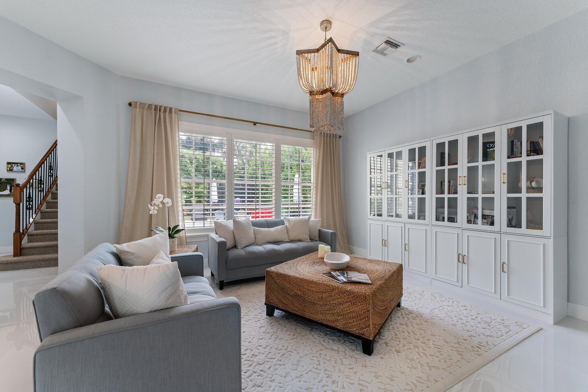 108 Via Azurra Jupiter, FL 33458 - Photo 11 of 78 a living room with furniture and a window