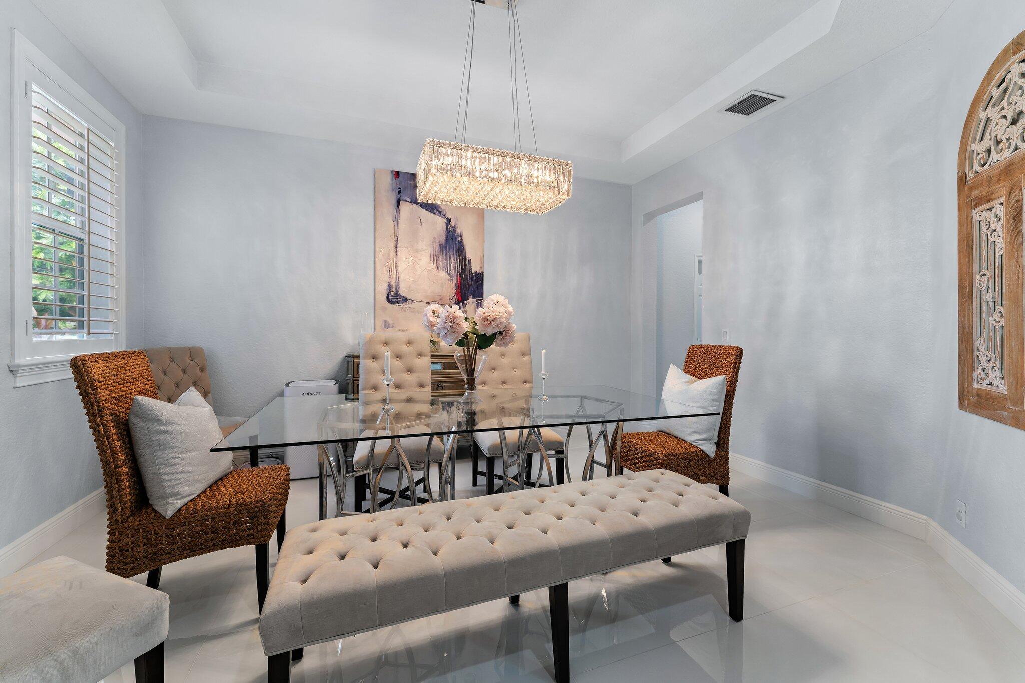 108 Via Azurra Jupiter, FL 33458 - Photo 17 of 78 a view of a dining room with furniture and wooden floor