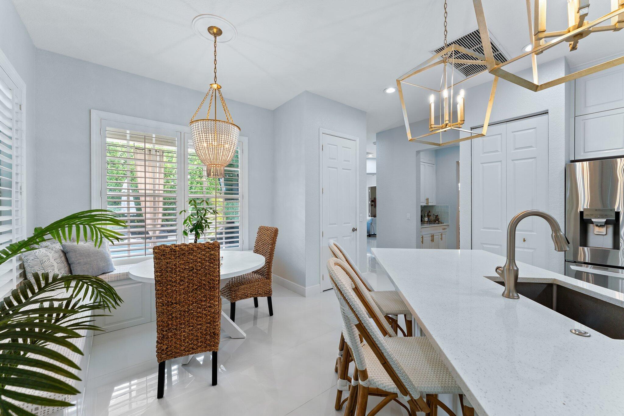 108 Via Azurra Jupiter, FL 33458 - Photo 27 of 78 a dining room with furniture a chandelier and window