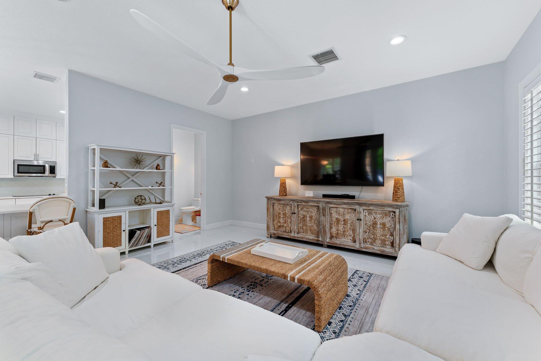108 Via Azurra Jupiter, FL 33458 - Photo 29 of 78 a living room with furniture and a flat screen tv