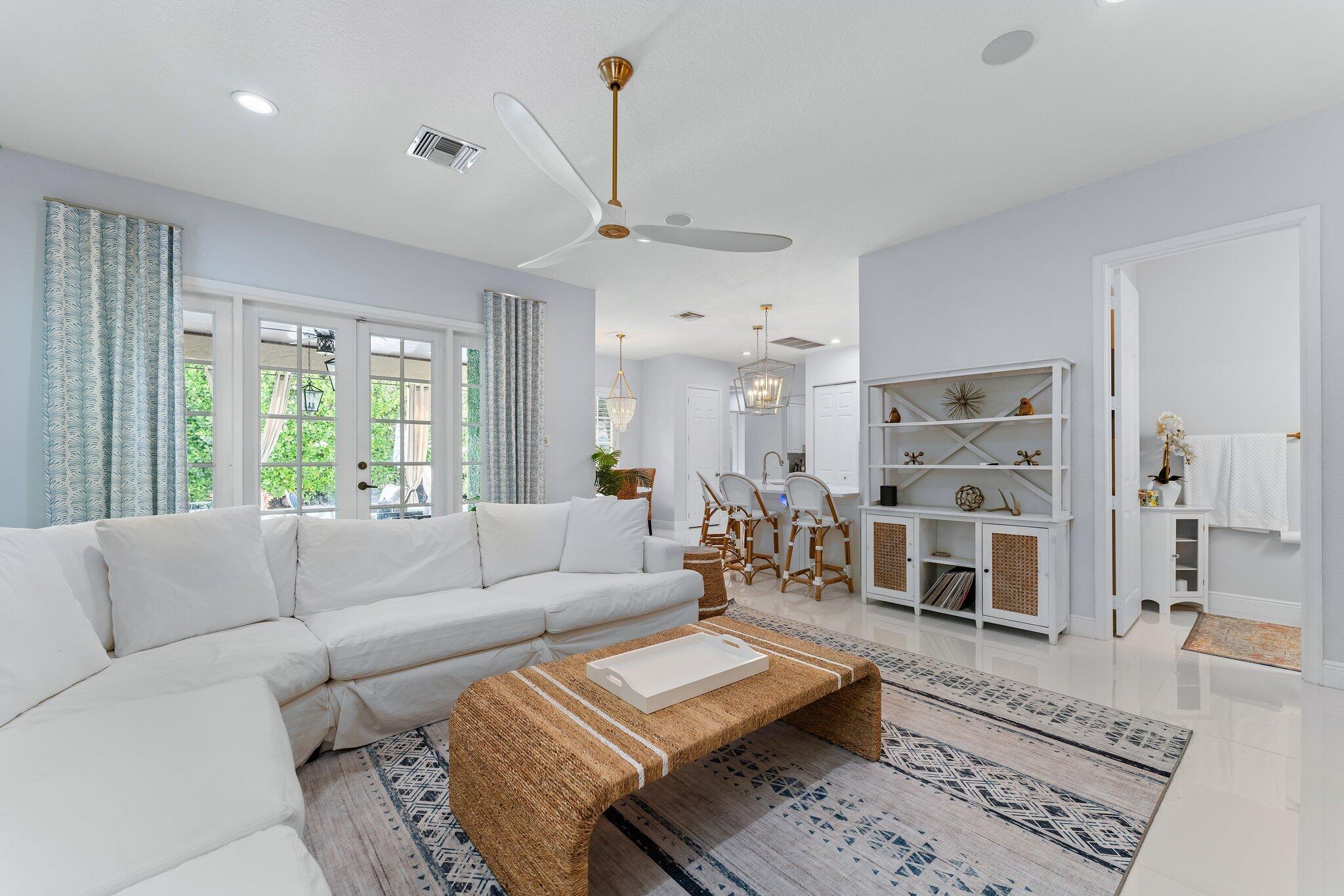 108 Via Azurra Jupiter, FL 33458 - Photo 31 of 78 a living room with furniture and a large window