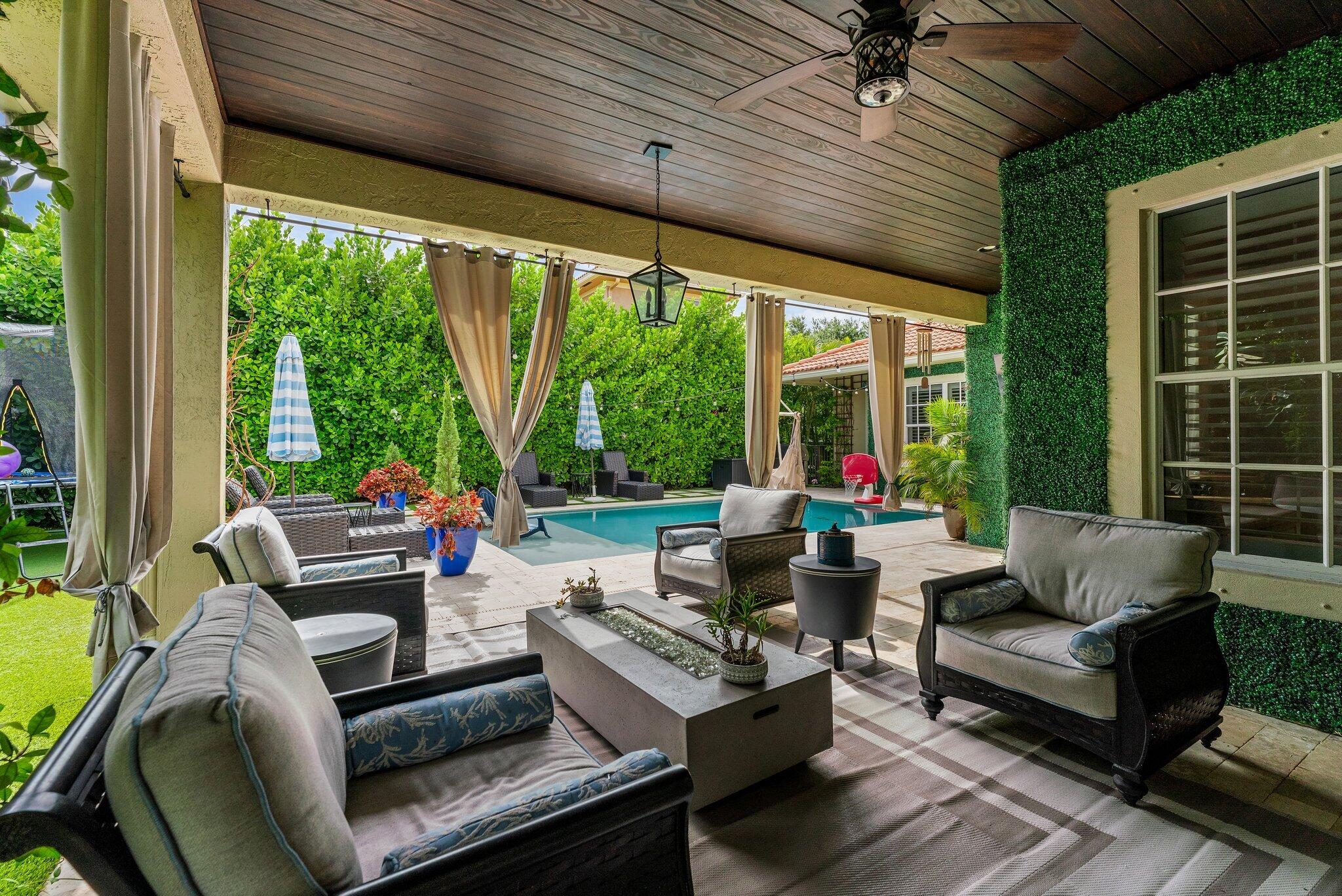 108 Via Azurra Jupiter, FL 33458 - Photo 33 of 78 a outdoor living space with patio furniture and garden view