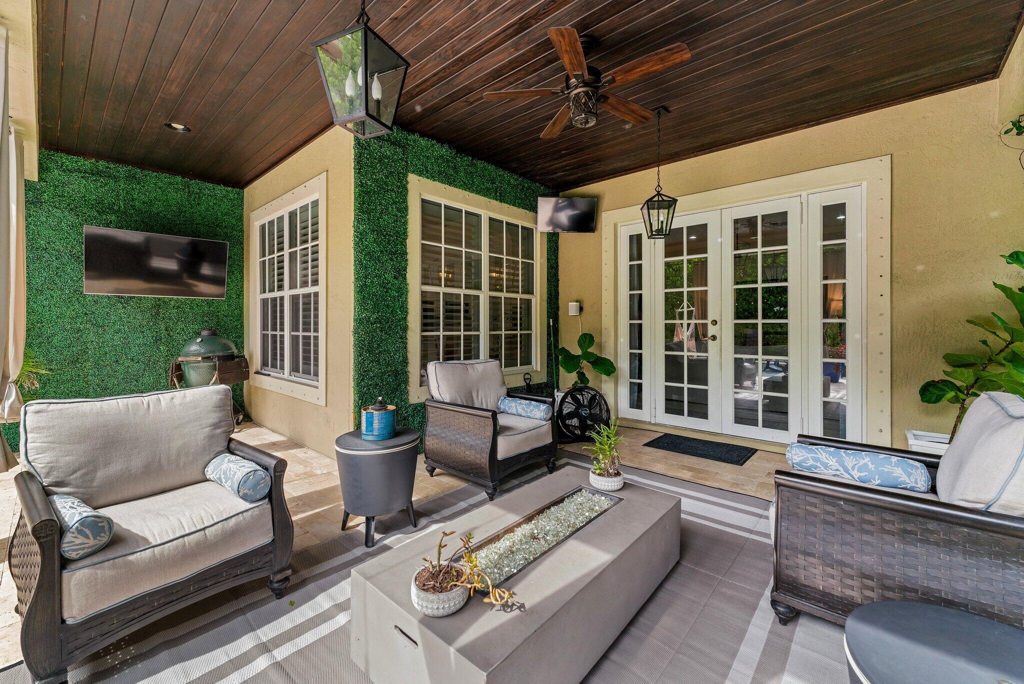 108 Via Azurra Jupiter, FL 33458 - Photo 36 of 78 a building outdoor space with patio furniture and garden