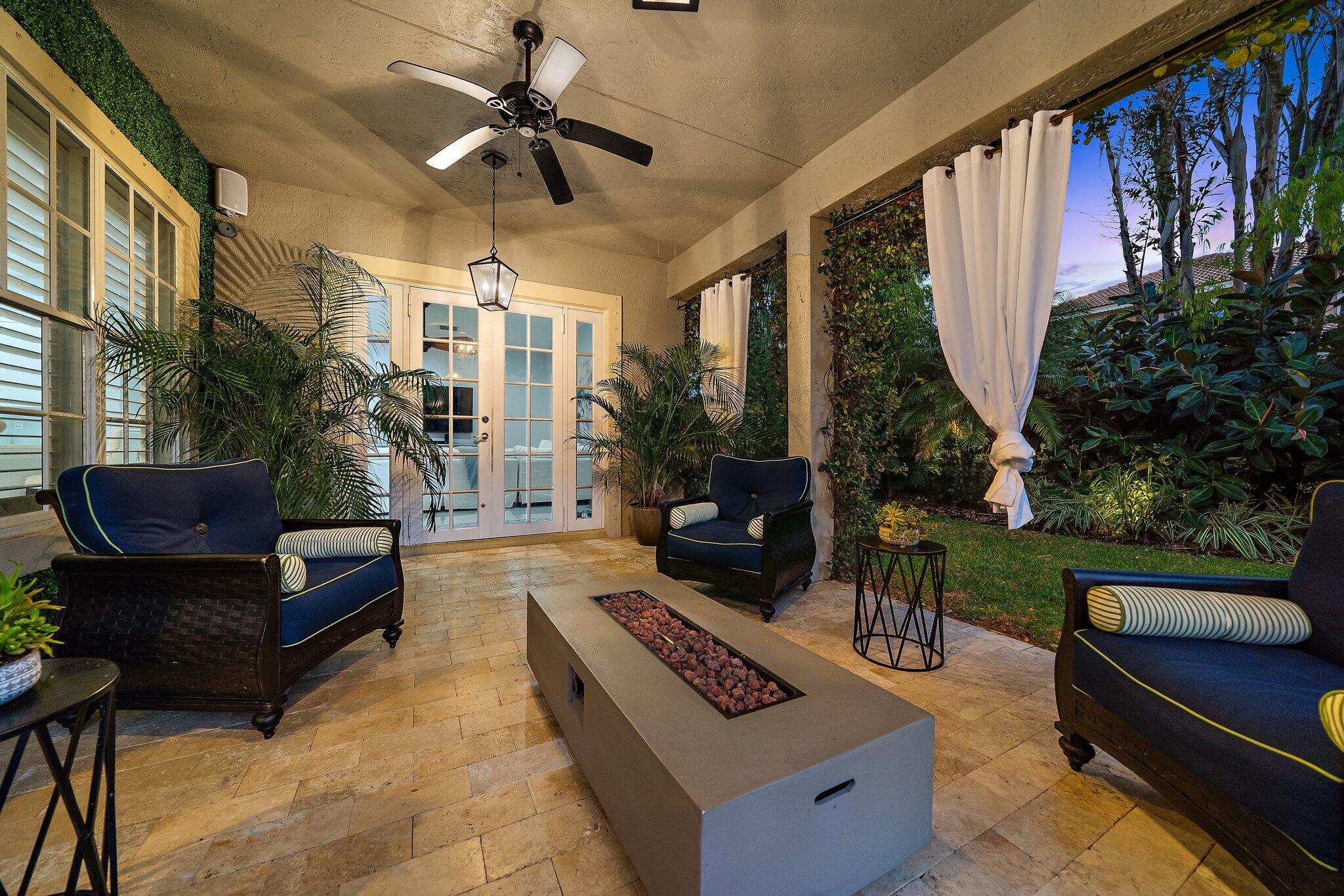 108 Via Azurra Jupiter, FL 33458 - Photo 37 of 78 a living room with furniture and a floor to ceiling window