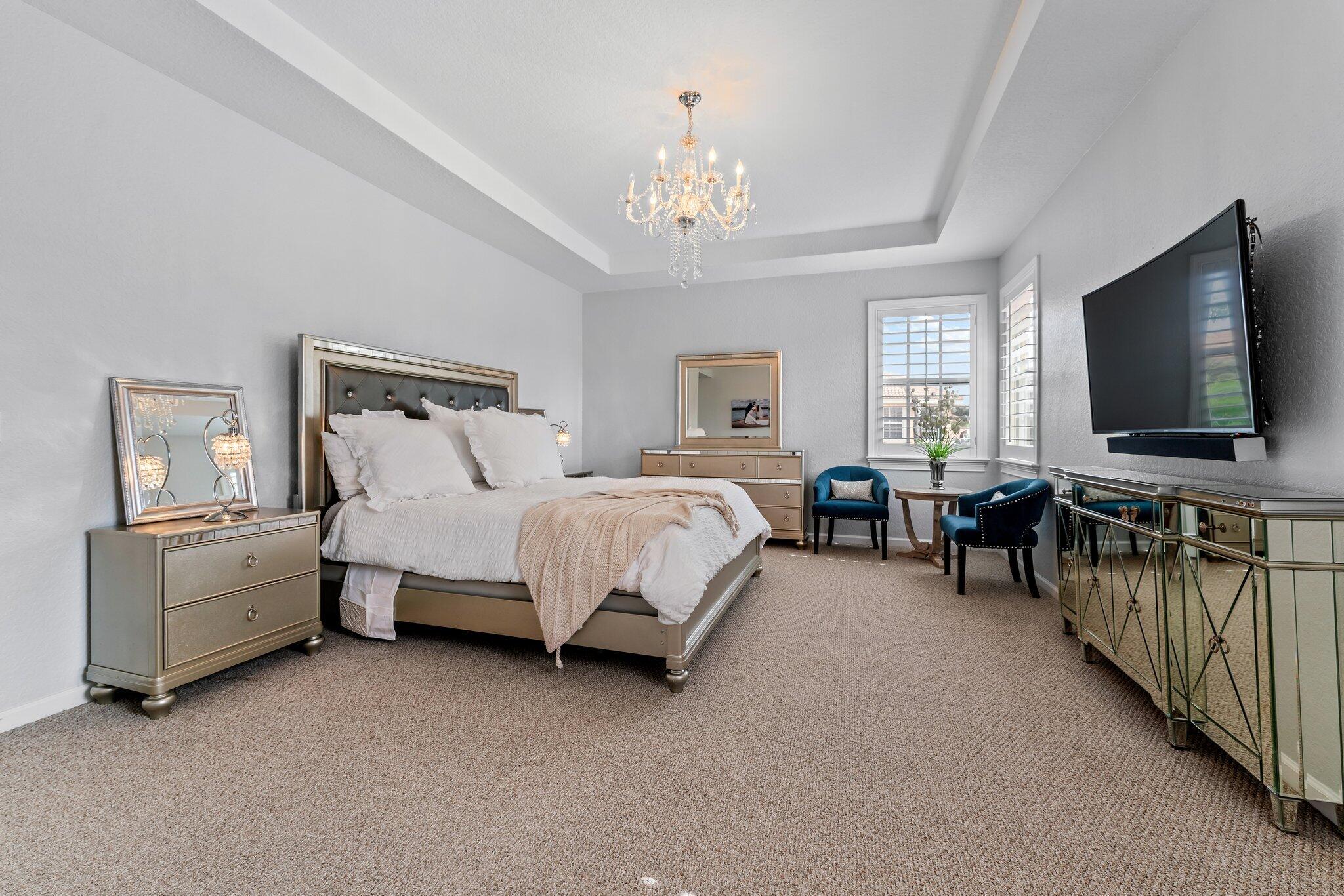 108 Via Azurra Jupiter, FL 33458 - Photo 44 of 78 a spacious bedroom with bed tv and window