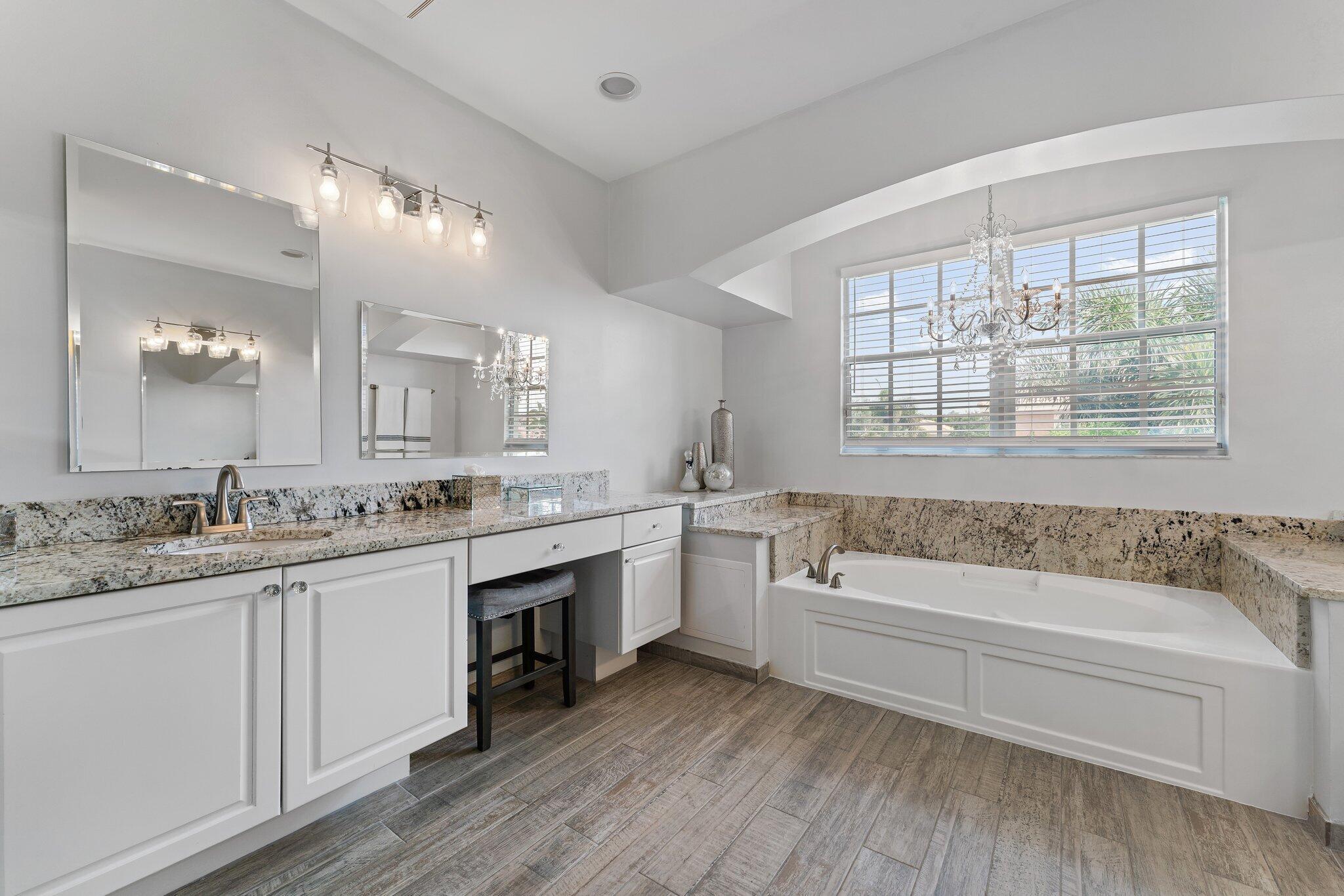 108 Via Azurra Jupiter, FL 33458 - Photo 49 of 78 a bathroom with a granite countertop tub sink and mirror
