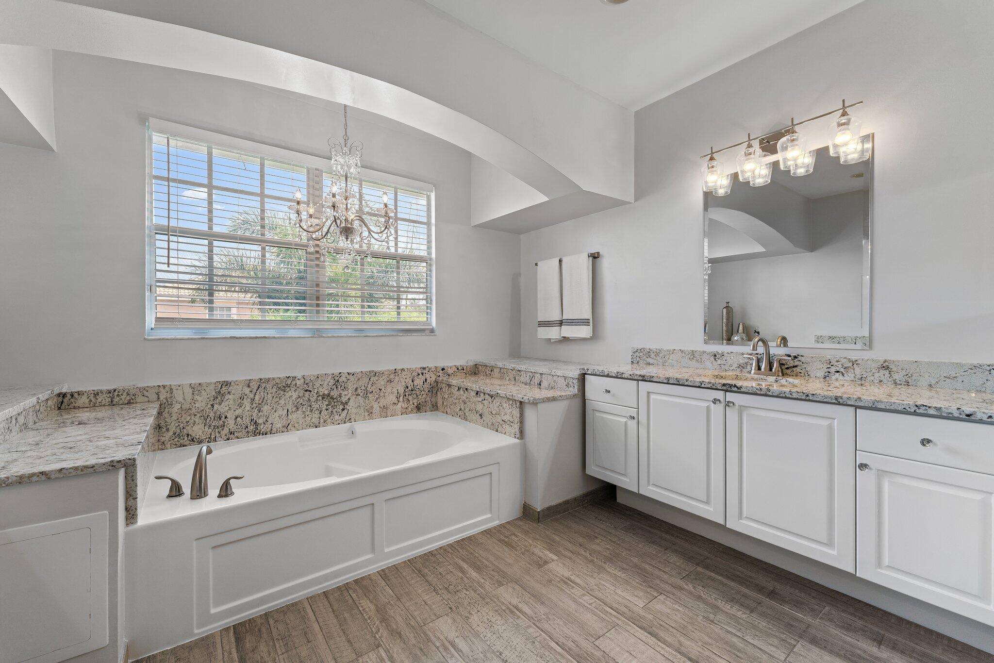 108 Via Azurra Jupiter, FL 33458 - Photo 50 of 78 a bathroom with a granite countertop tub sink and mirror