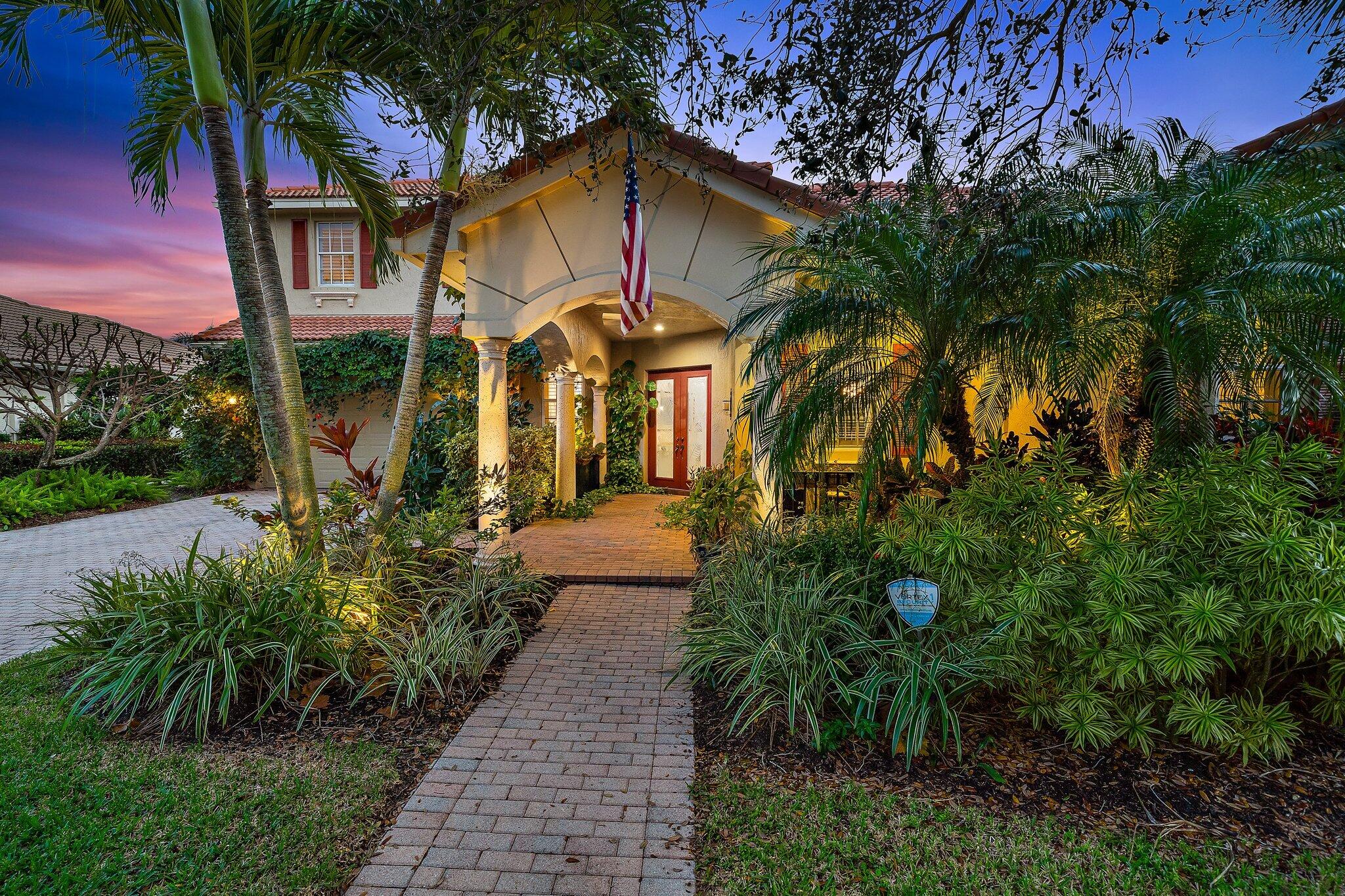 108 Via Azurra Jupiter, FL 33458 - Photo 5 of 78 a front view of a house with a yard