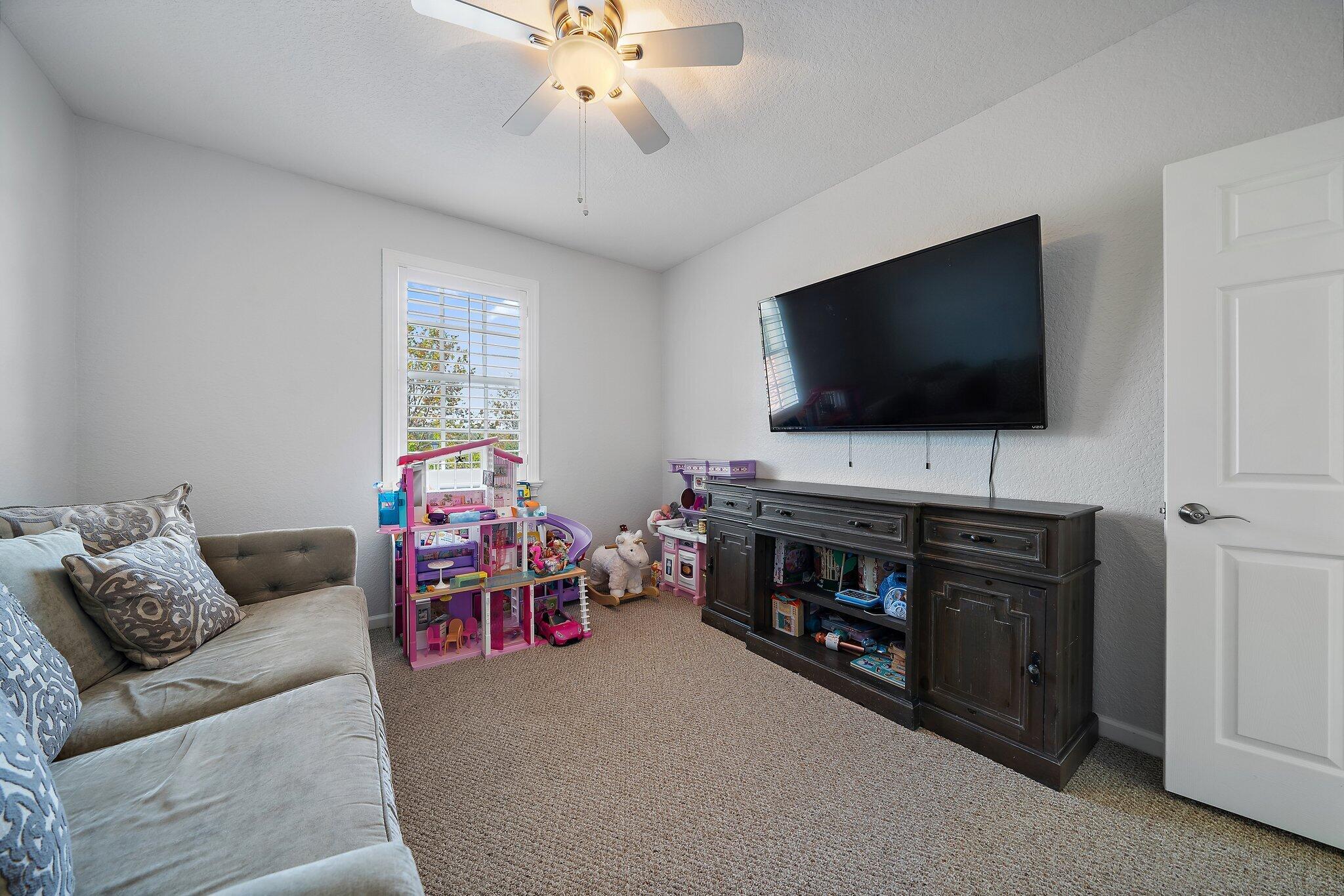 108 Via Azurra Jupiter, FL 33458 - Photo 57 of 78 a living room with furniture and a flat screen tv