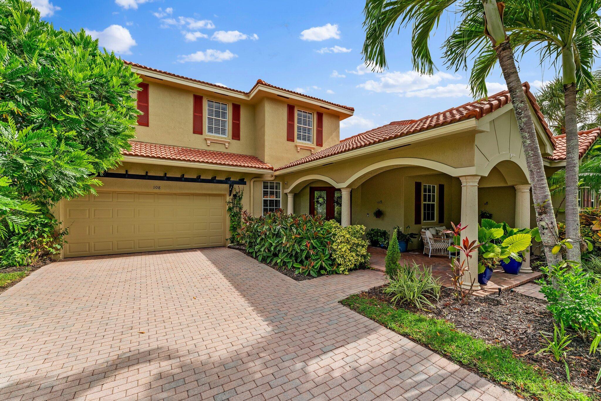 108 Via Azurra Jupiter, FL 33458 - Photo 6 of 78 a front view of a house with garden