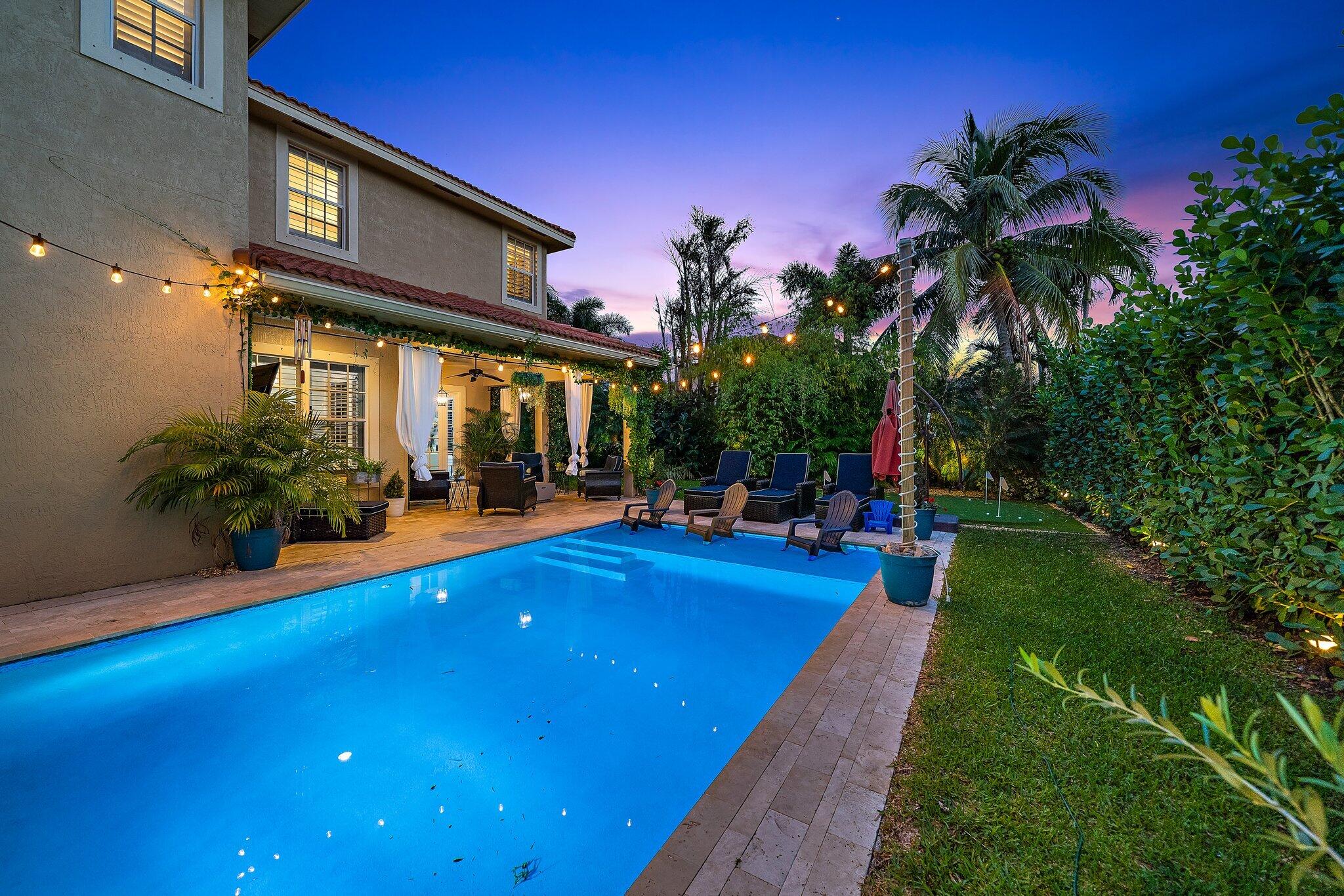 108 Via Azurra Jupiter, FL 33458 - Photo 65 of 78 a view of a house with swimming pool and sitting area