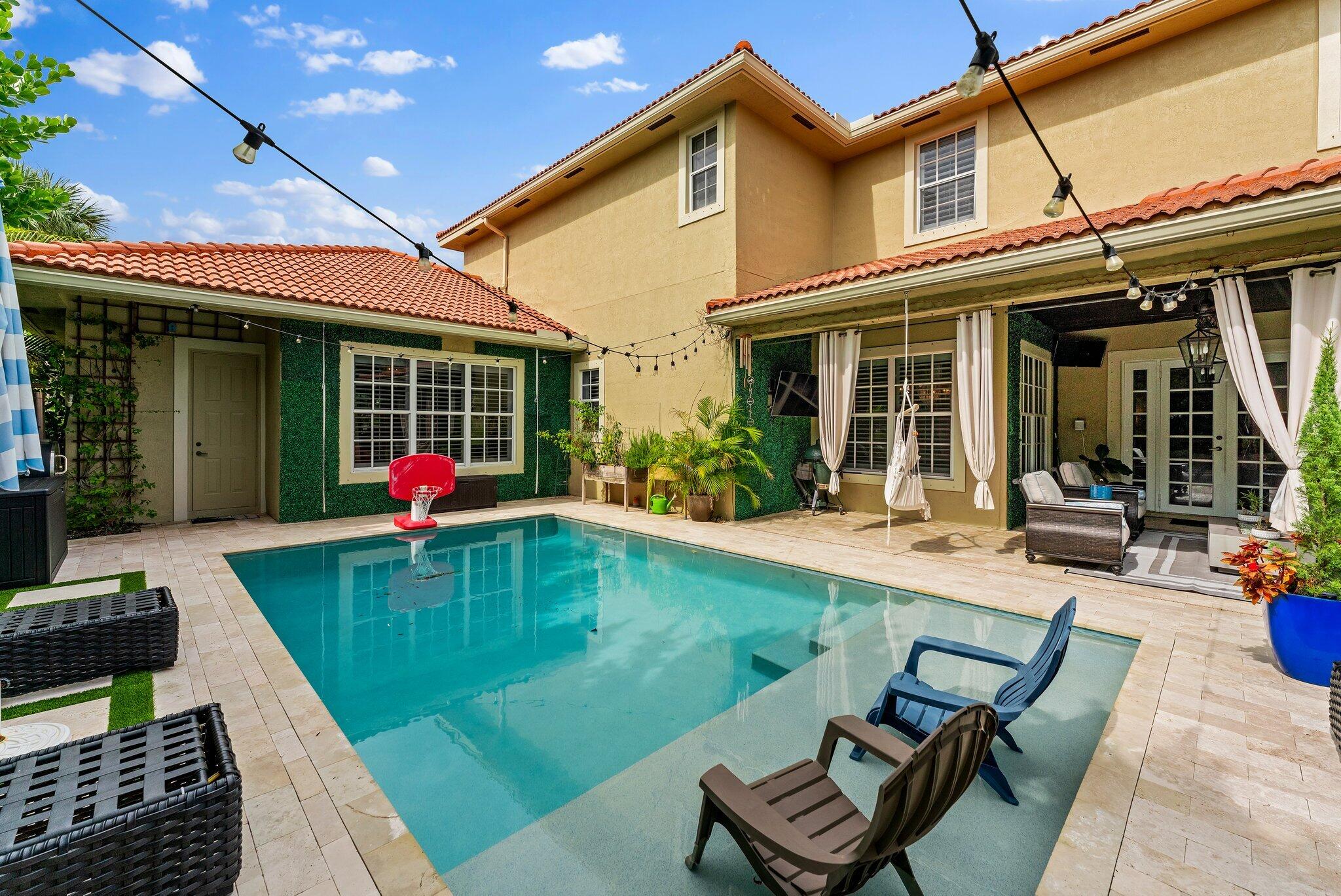 108 Via Azurra Jupiter, FL 33458 - Photo 69 of 78 a view of a house with swimming pool patio and a yard