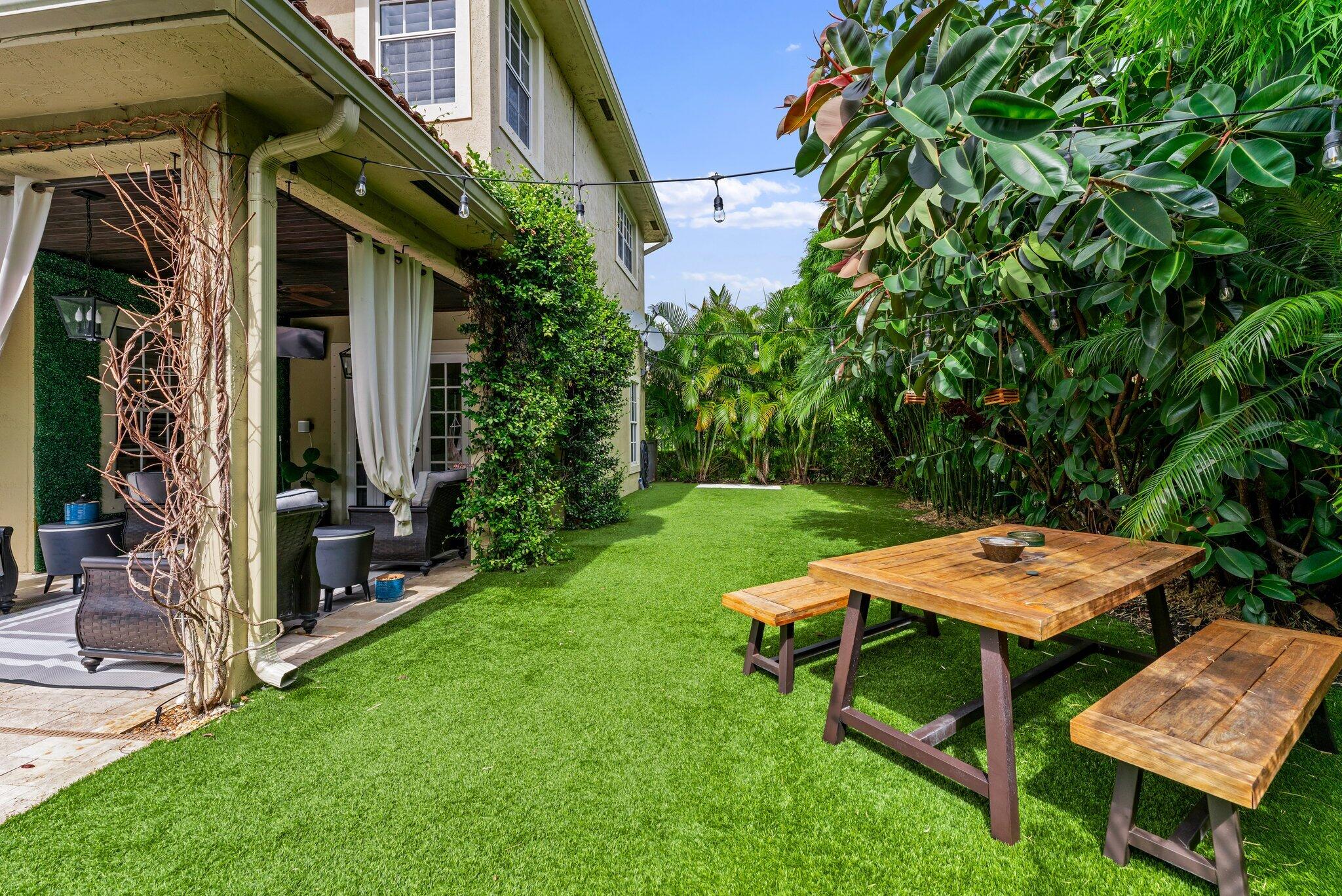 108 Via Azurra Jupiter, FL 33458 - Photo 72 of 78 a backyard of a house with outdoor seating