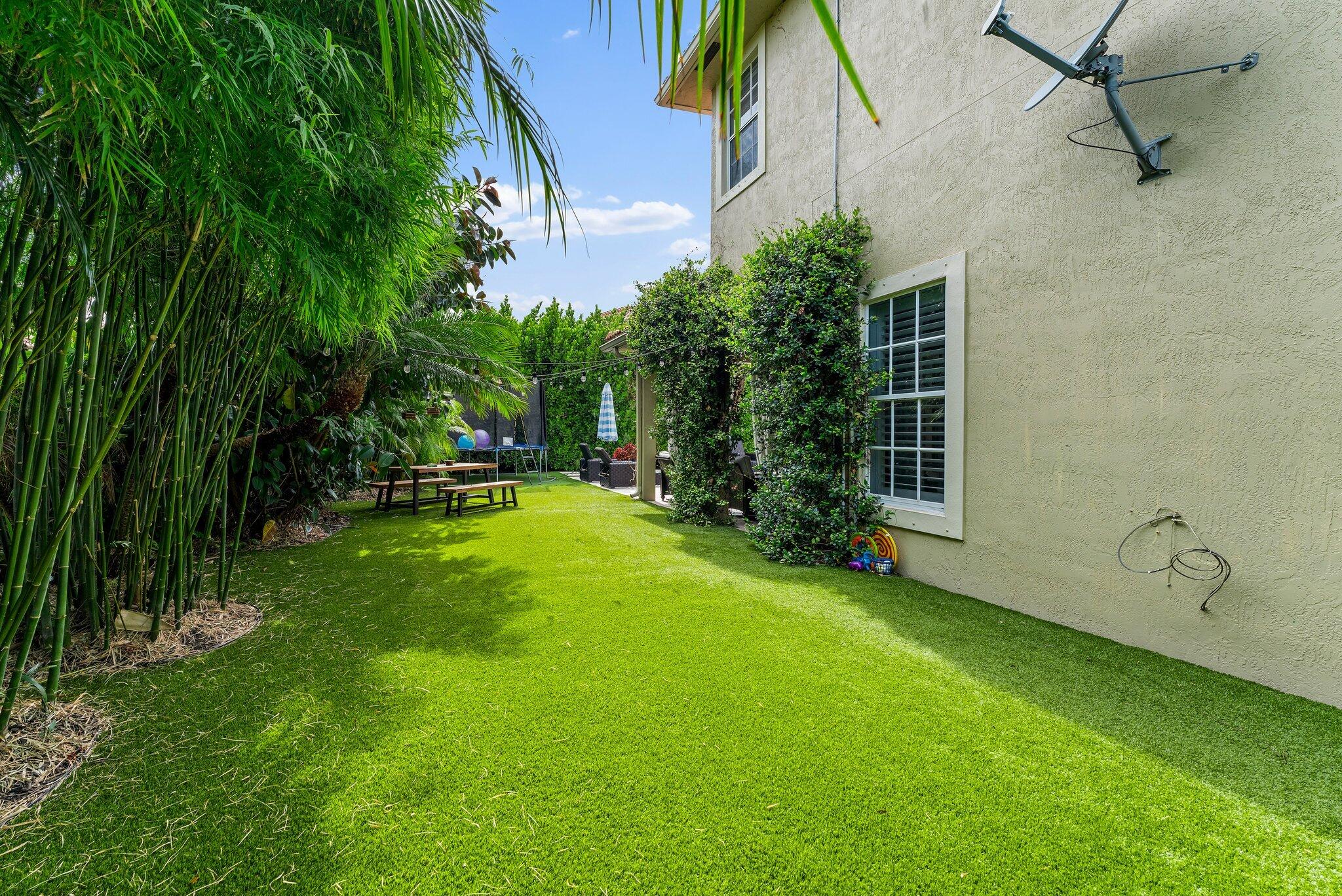 108 Via Azurra Jupiter, FL 33458 - Photo 74 of 78 a view of a backyard with a slide