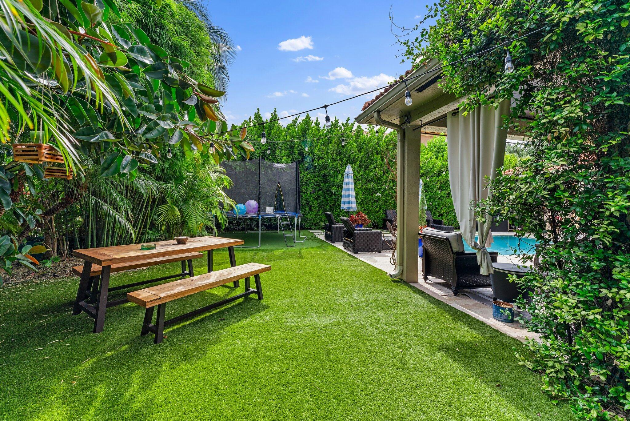 108 Via Azurra Jupiter, FL 33458 - Photo 75 of 78 a garden view with a seating space