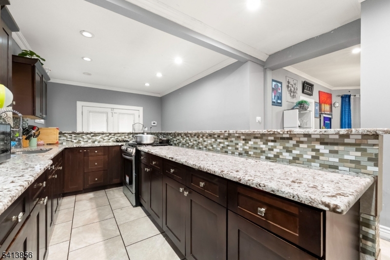 263 Stiles Street Elizabeth, NJ 07208 - Photo 13 of 30 a kitchen with granite countertop a sink and cabinets