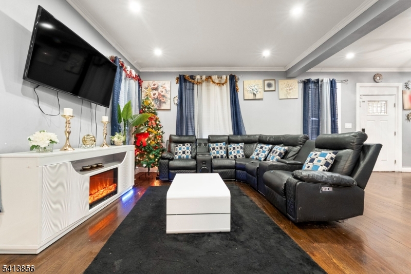 263 Stiles Street Elizabeth, NJ 07208 - Photo 7 of 30 a living room with furniture fireplace and flat screen tv