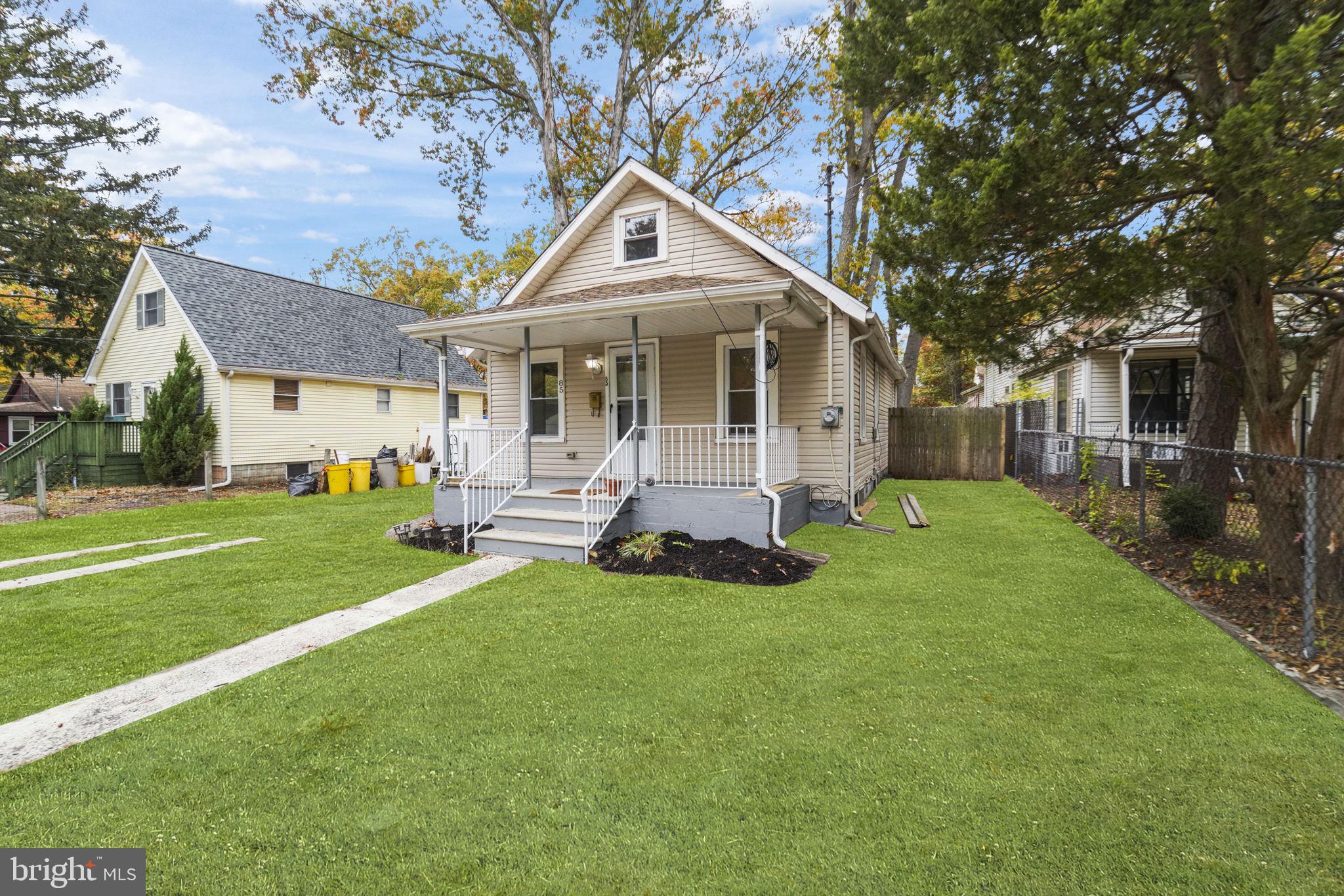 85 East 9th Avenue Pine Hill, NJ 08021 - Photo 3 of 27 a front view of a house with a yard garden and patio