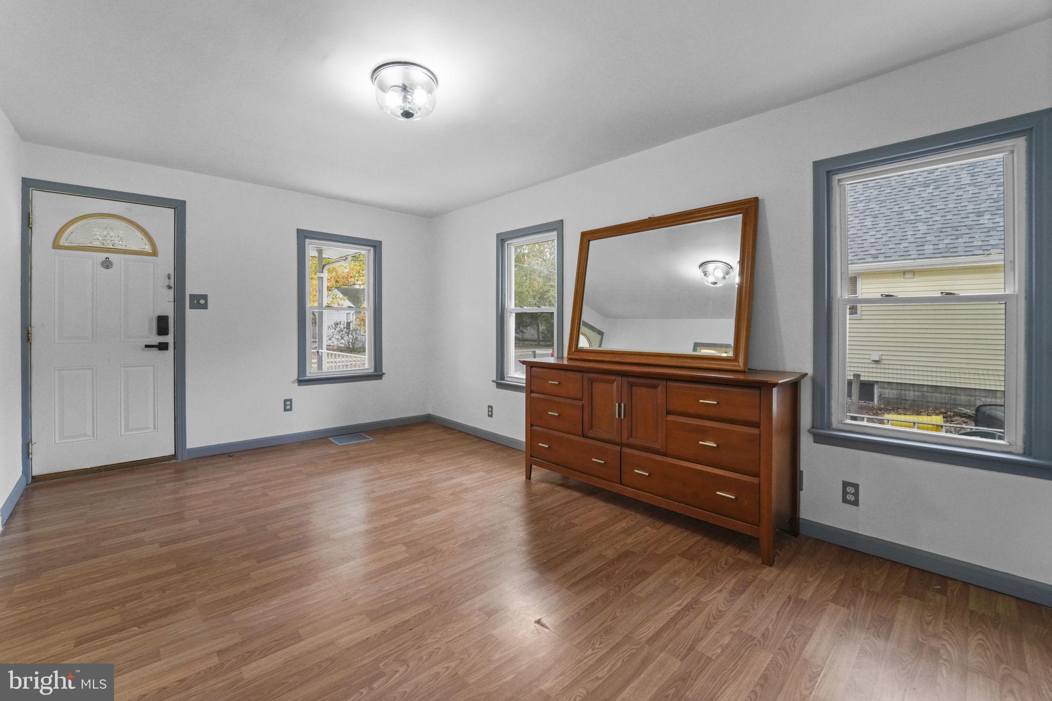 85 East 9th Avenue Pine Hill, NJ 08021 - Photo 4 of 27 an empty room with window and wooden floor