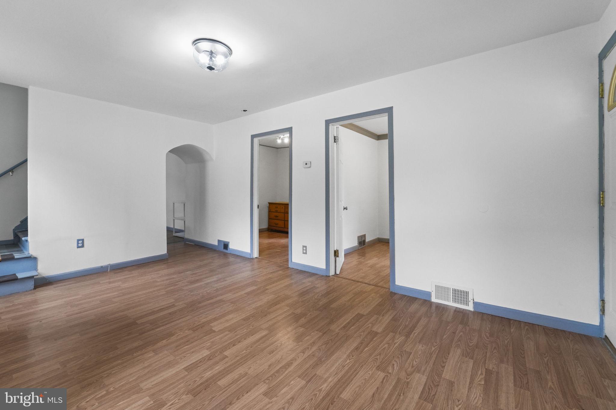 85 East 9th Avenue Pine Hill, NJ 08021 - Photo 6 of 27 an empty room with wooden floor and windows
