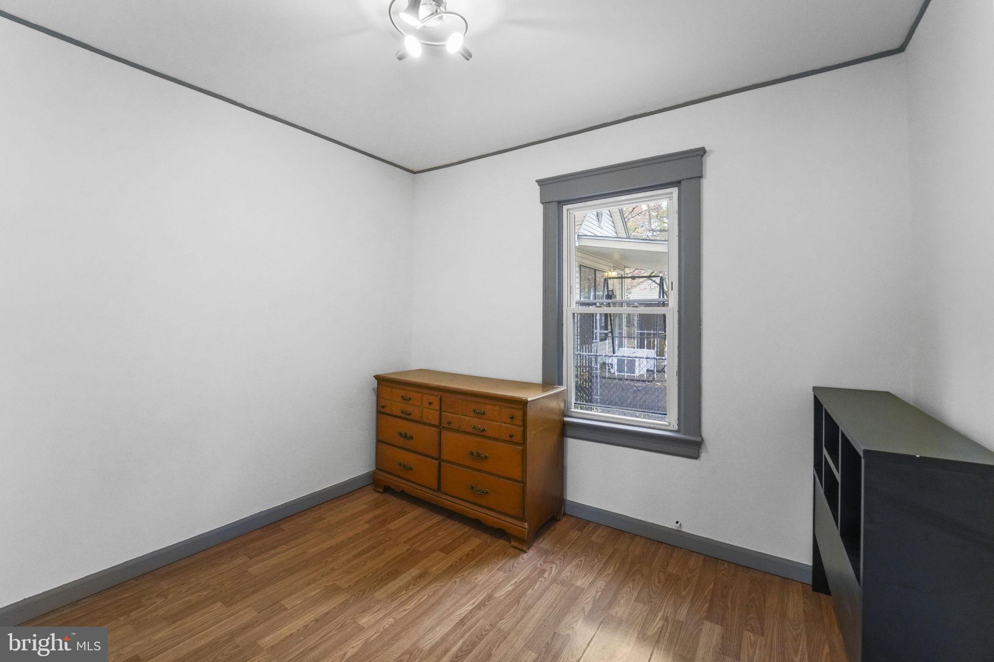 85 East 9th Avenue Pine Hill, NJ 08021 - Photo 9 of 27 a room with wooden floor and windows