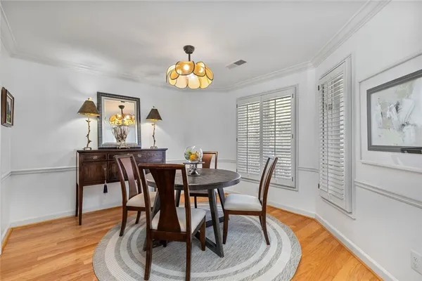 a view of a dining room with furniture and wooden floor