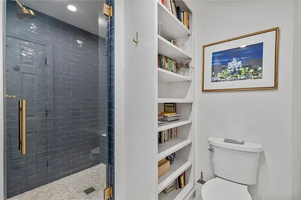 a bathroom with a toilet and a shower
