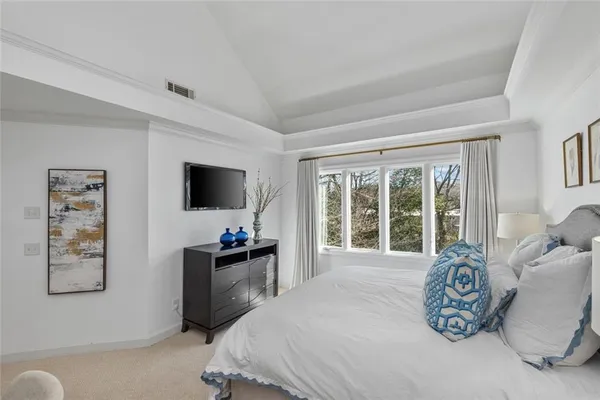 a bedroom with furniture and a flat screen tv
