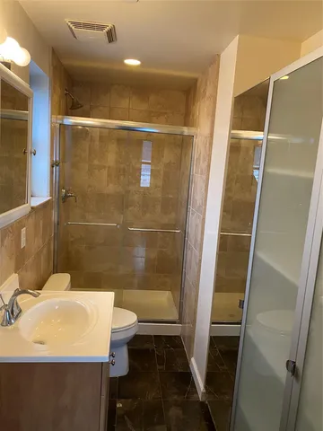 a bathroom with a sink toilet and shower