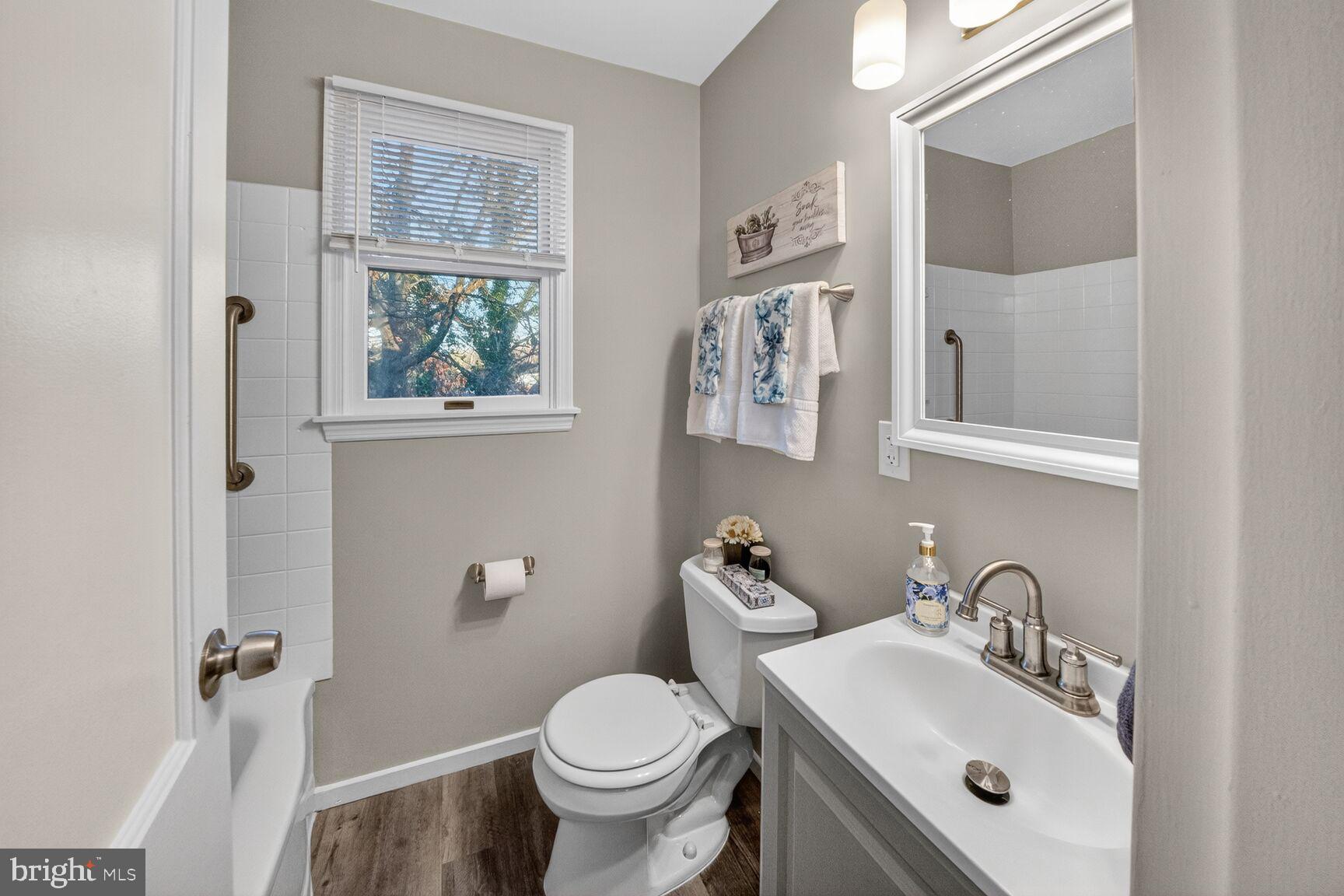 3033 Medway Street Silver Spring, MD 20902 - Photo 24 of 52 a bathroom with a sink toilet and a mirror