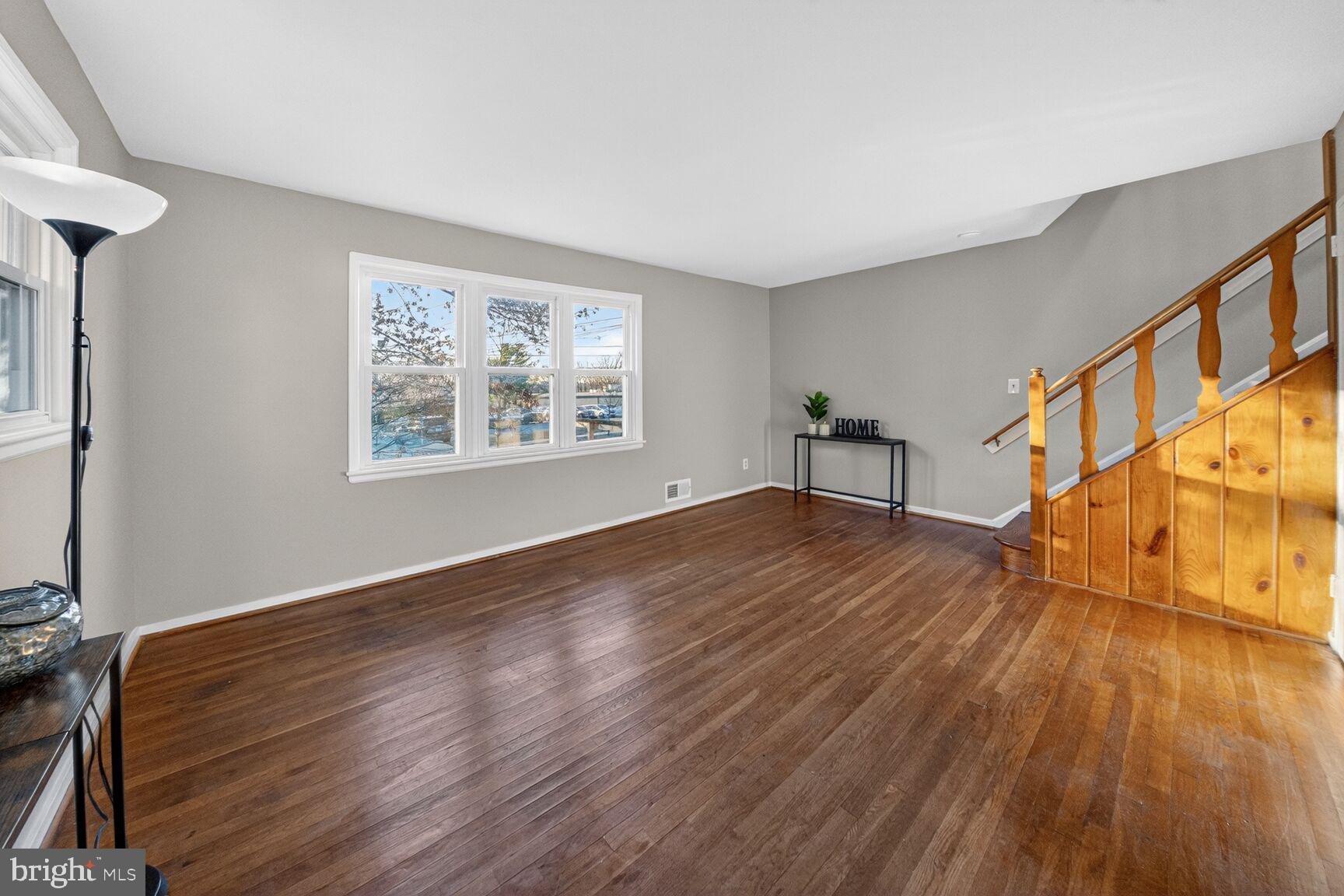 3033 Medway Street Silver Spring, MD 20902 - Photo 4 of 52 a view of an empty room with wooden floor and a window