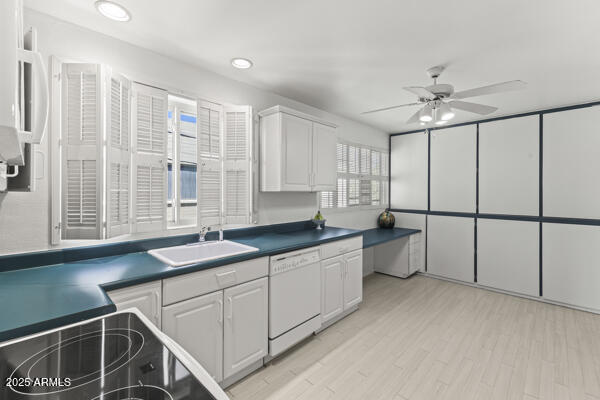500 West Clarendon Avenue, Unit D6 Phoenix, AZ 85013 - Photo 12 of 23 a large white kitchen with granite countertop a sink and white cabinets