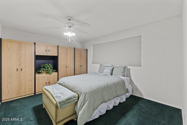 500 West Clarendon Avenue, Unit D6 Phoenix, AZ 85013 - Photo 13 of 23 a bedroom with a bed chandelier and a window