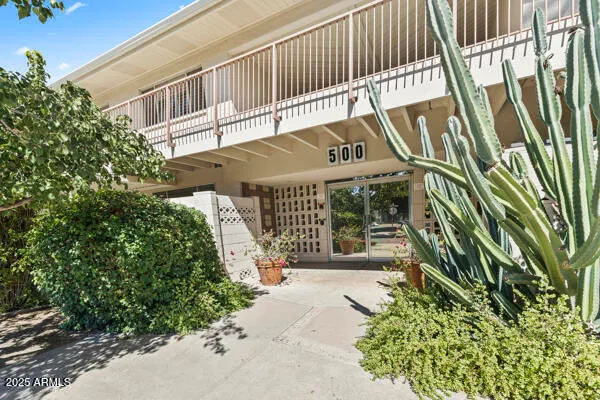 a bedroom with a bed chandelier and a window