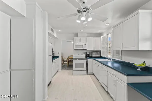 an empty room with a window and a ceiling fan