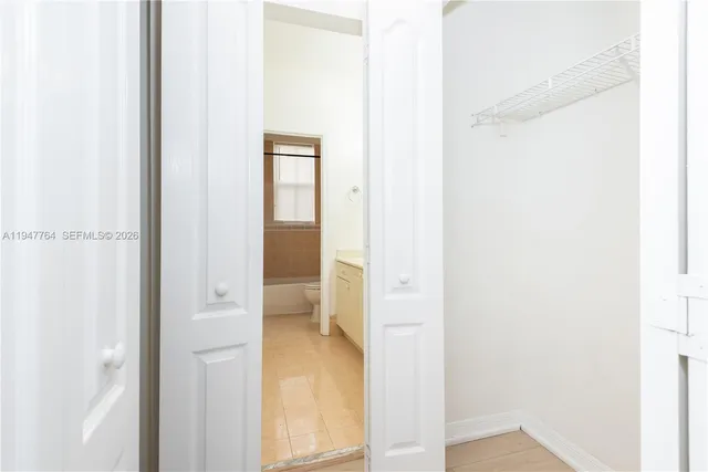 a view of a bathroom from a hallway