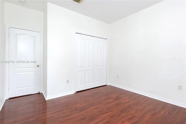 an empty room with wooden floor