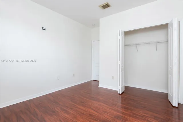 an empty room with wooden floor