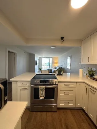 a kitchen with a stove and white cabinets