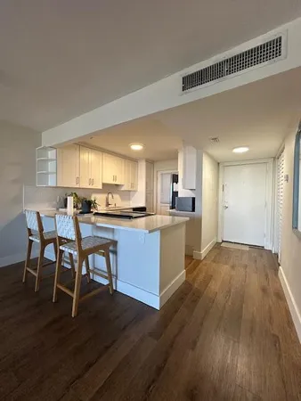 a view of kitchen with sink and wooden floor