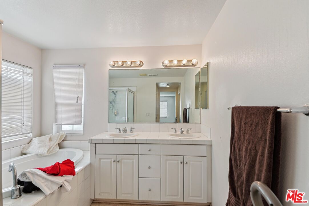 3012 Dunkirk Drive Oxnard, CA 93035 - Photo 14 of 29 a spacious bathroom with a granite countertop sink and a mirror