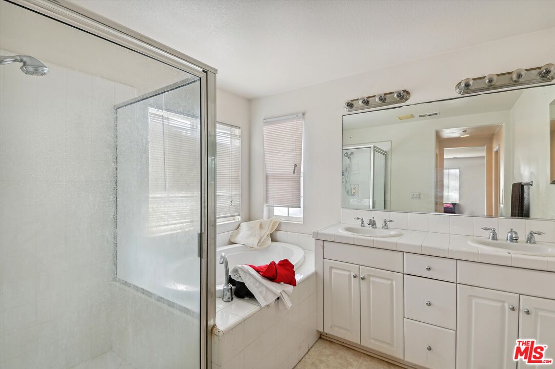 3012 Dunkirk Drive Oxnard, CA 93035 - Photo 16 of 29 a bathroom with a double vanity sink mirror and shower